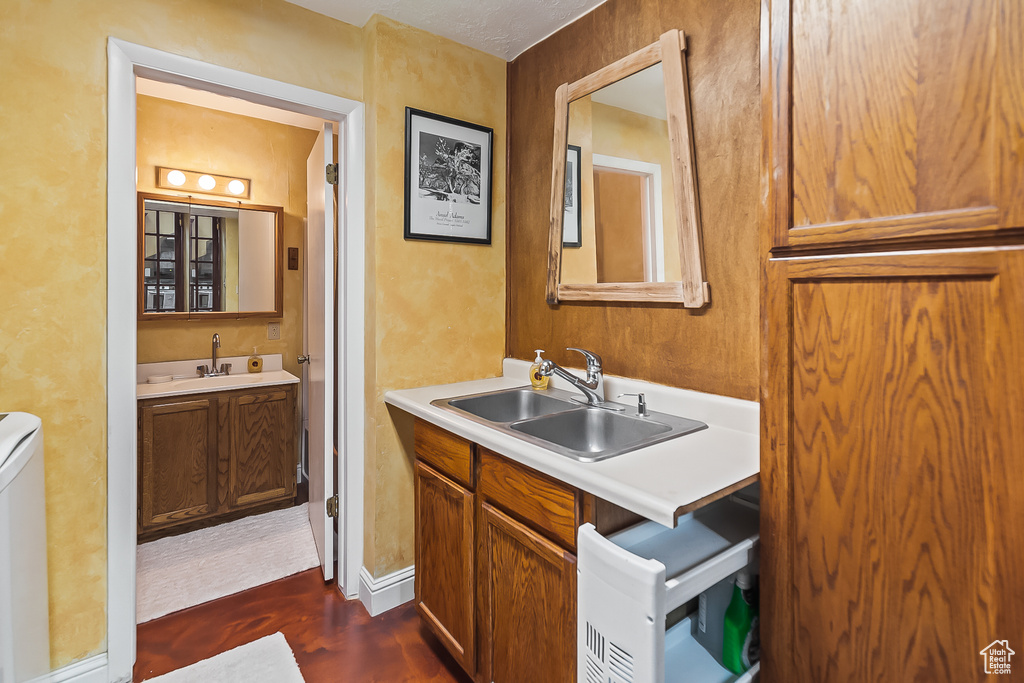 Bathroom with wood finished floors, two vanities, and toilet