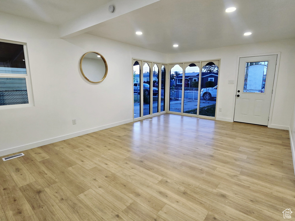 Spare room featuring light wood-style flooring, baseboards, recessed lighting, and a smoke detector