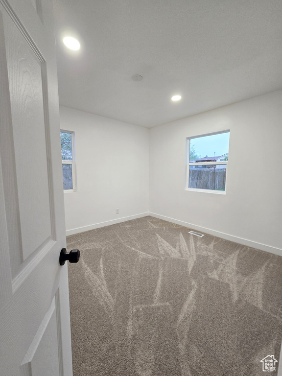 Unfurnished room featuring carpet flooring, baseboards, plenty of natural light, and recessed lighting