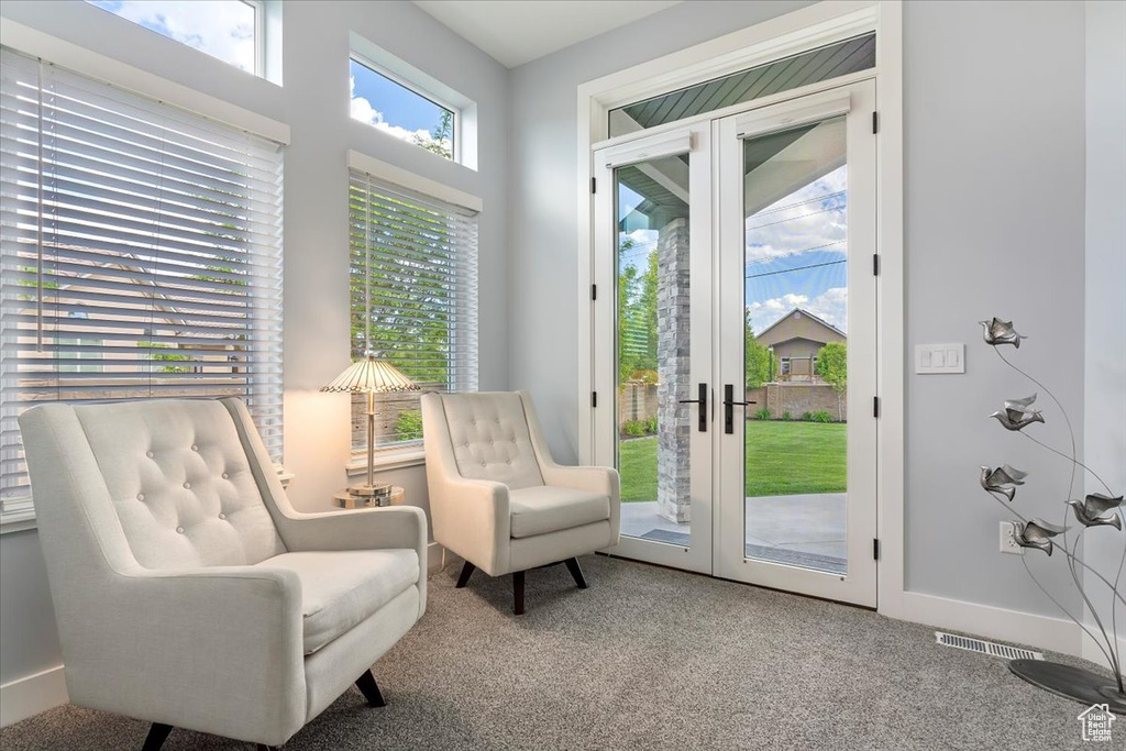 Sitting room featuring carpet floors, baseboards, and french doors