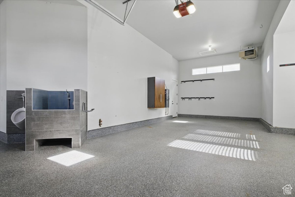 Garage with a garage door opener and baseboards