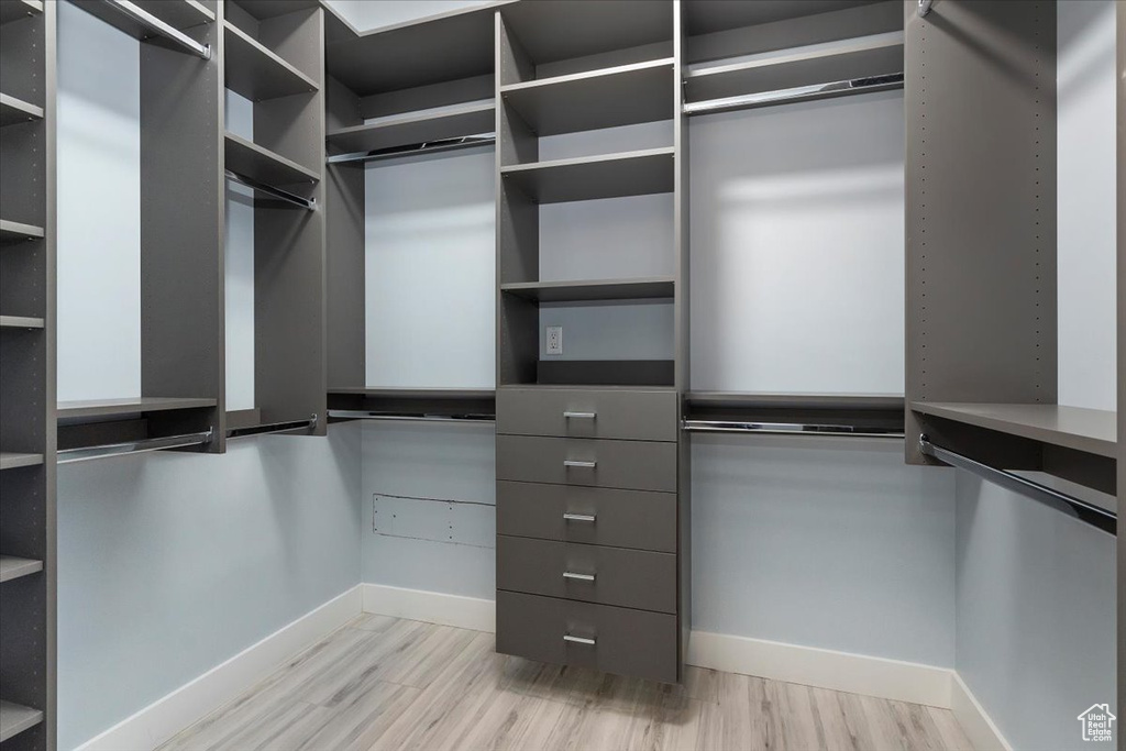 Walk in closet featuring light wood-style floors