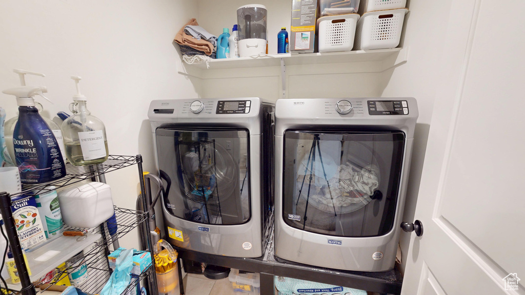 Washroom featuring washing machine and clothes dryer