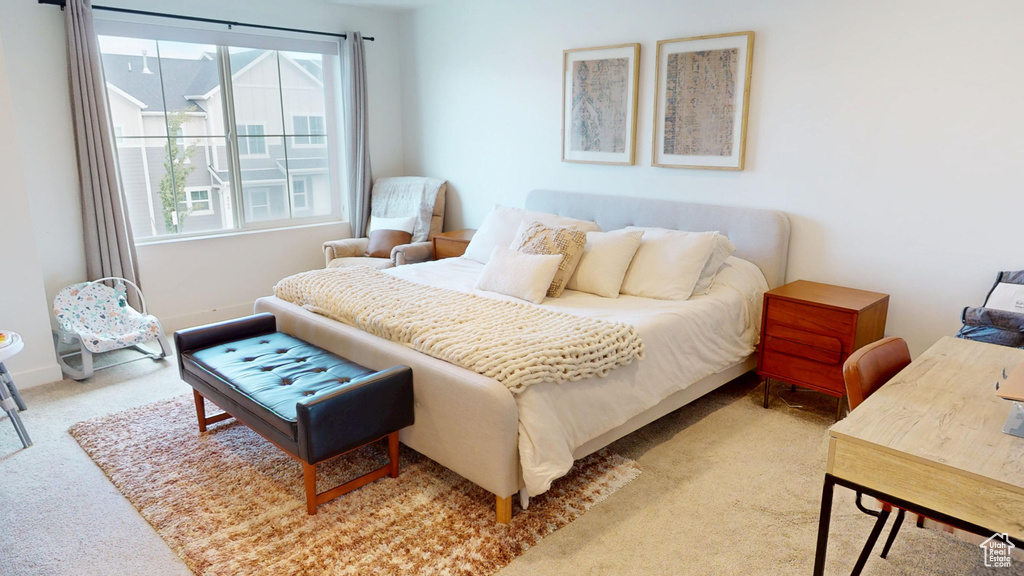 Carpeted bedroom with multiple windows