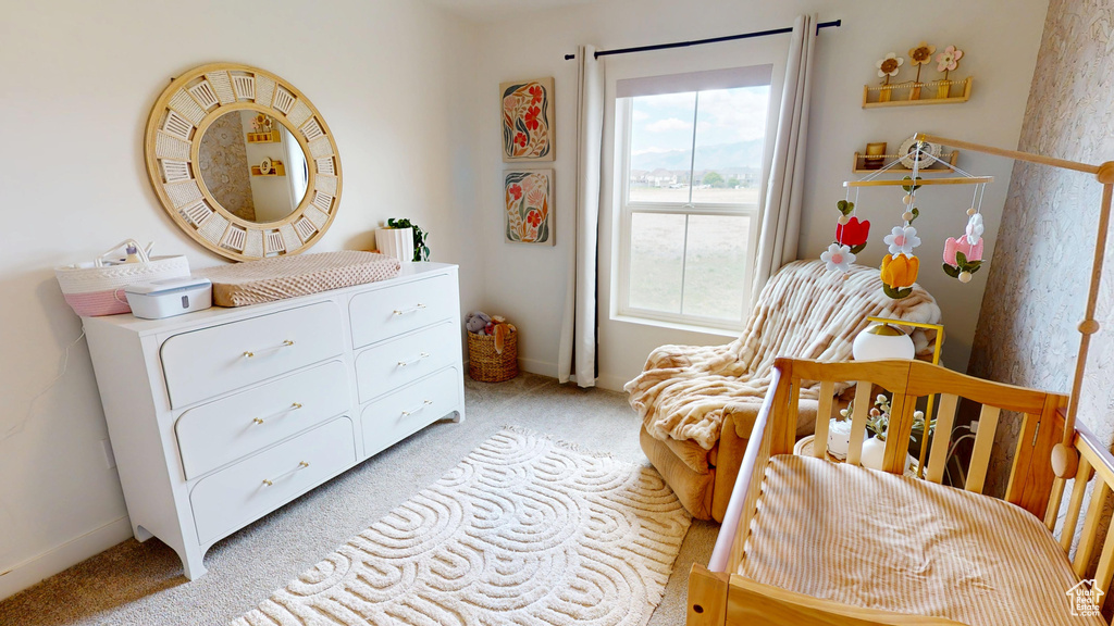 Bedroom with light carpet and baseboards