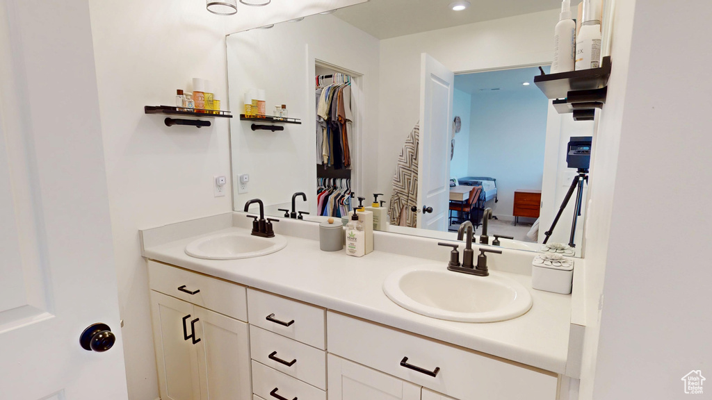 Ensuite bathroom with double vanity and recessed lighting