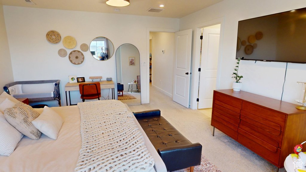 Carpeted bedroom featuring arched walkways and recessed lighting