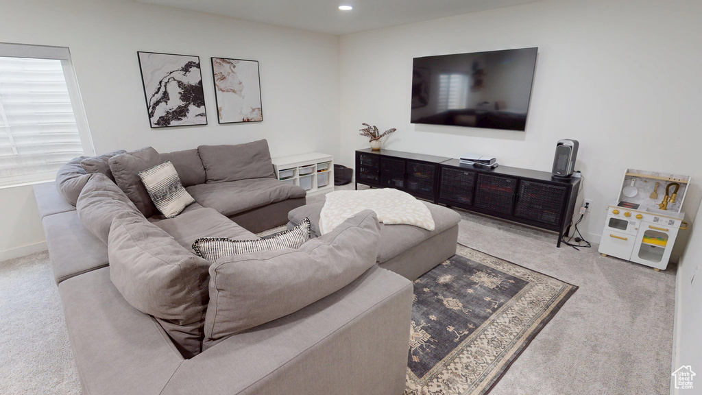 Living area with carpet, baseboards, and recessed lighting