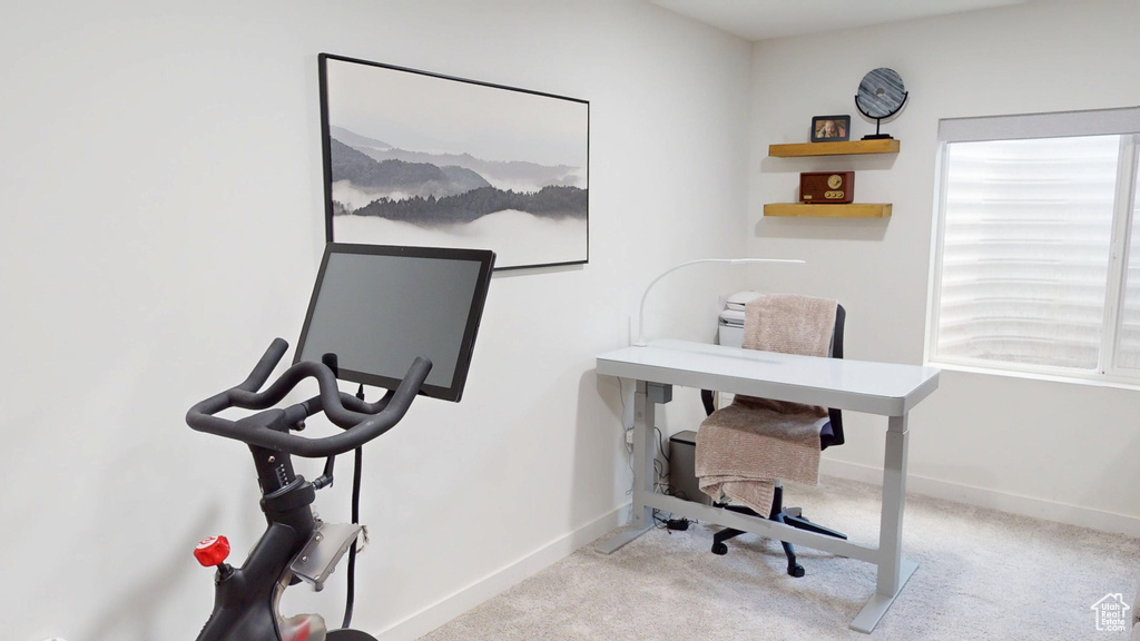 Home office featuring carpet and baseboards