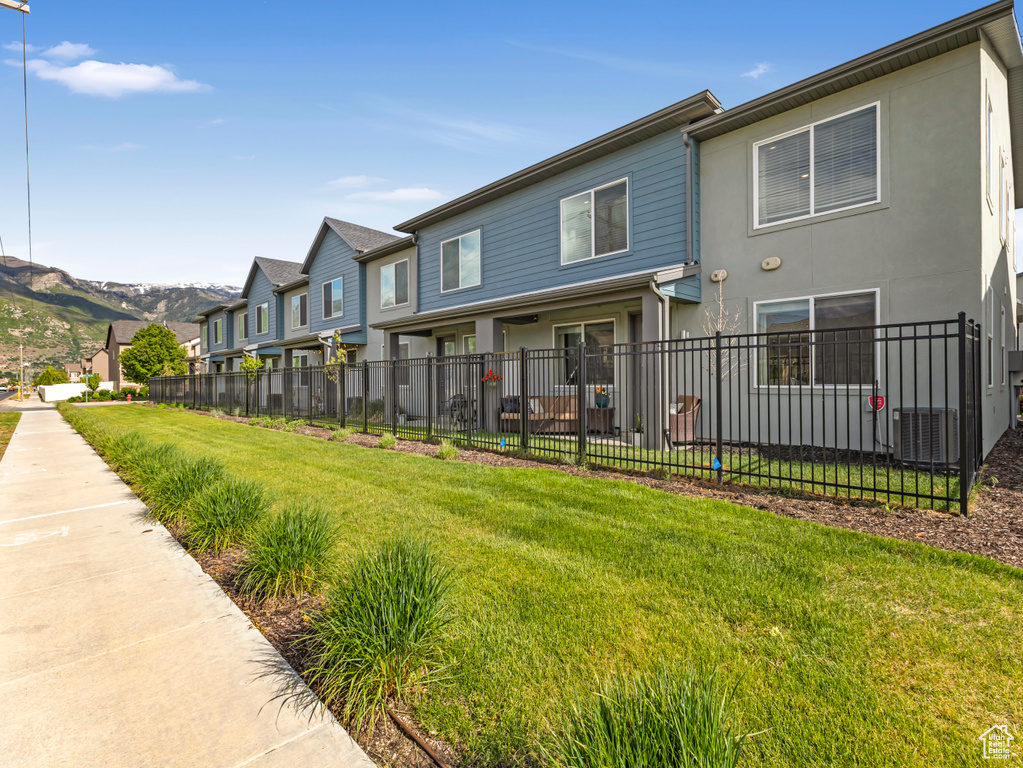 Back of property featuring cooling unit and stucco siding