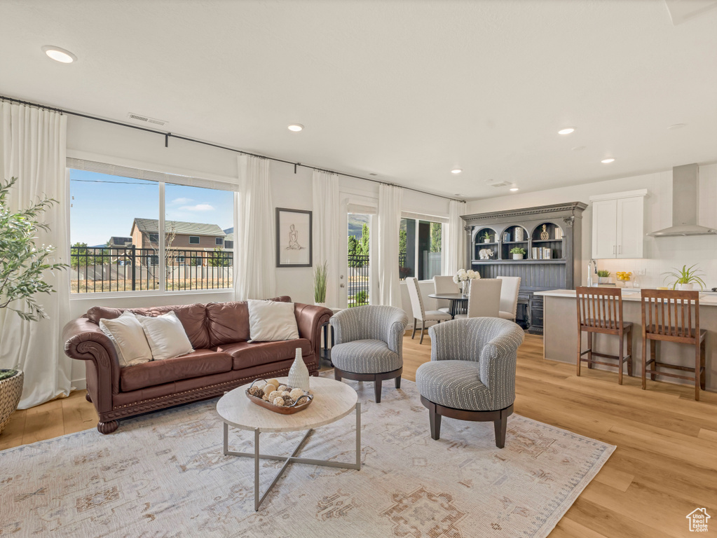 Living room featuring recessed lighting and light wood-type flooring