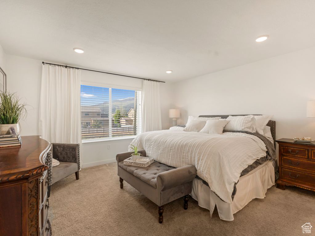 Bedroom with light carpet, recessed lighting, and baseboards