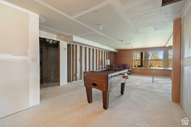 Recreation room with unfinished concrete floors