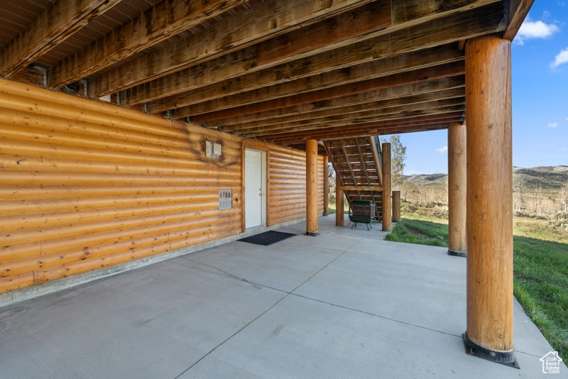 View of patio with stairs and a mountain view