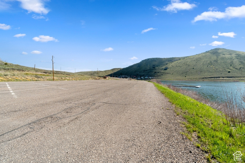 View of asphalt street featuring a water and mountain view