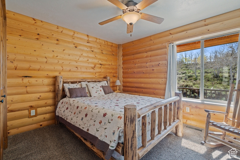 Carpeted bedroom with rustic walls