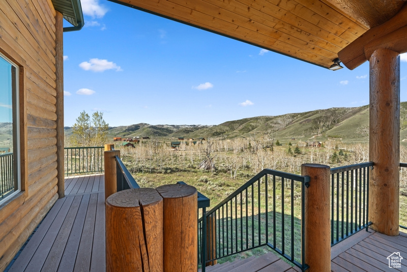 Wooden deck with a mountain view and a rural view