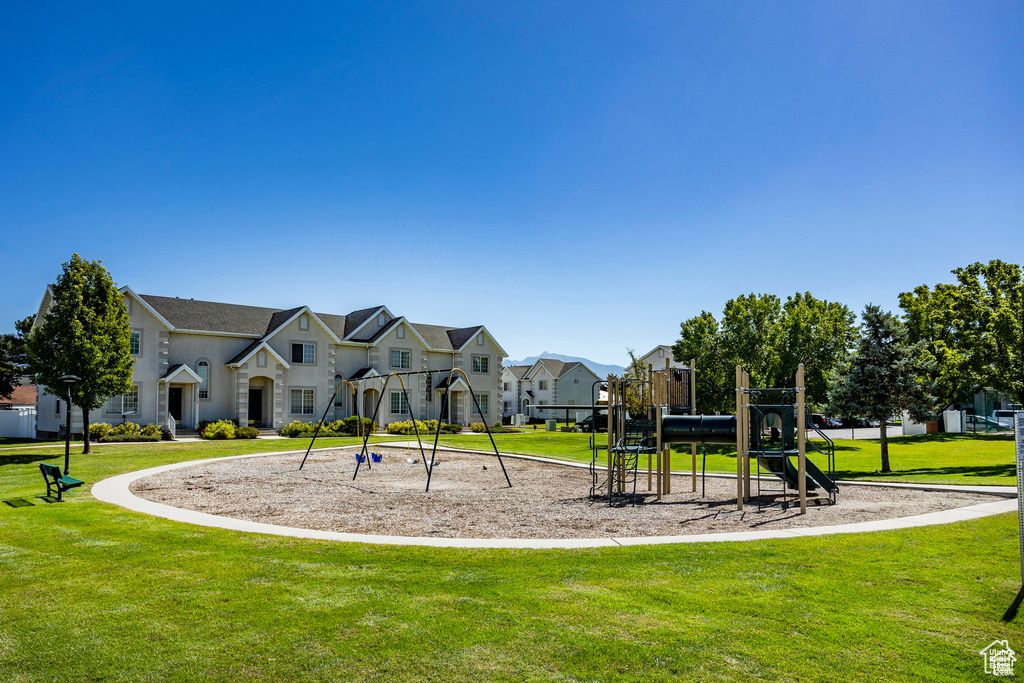 Community playground featuring a residential view and a lawn