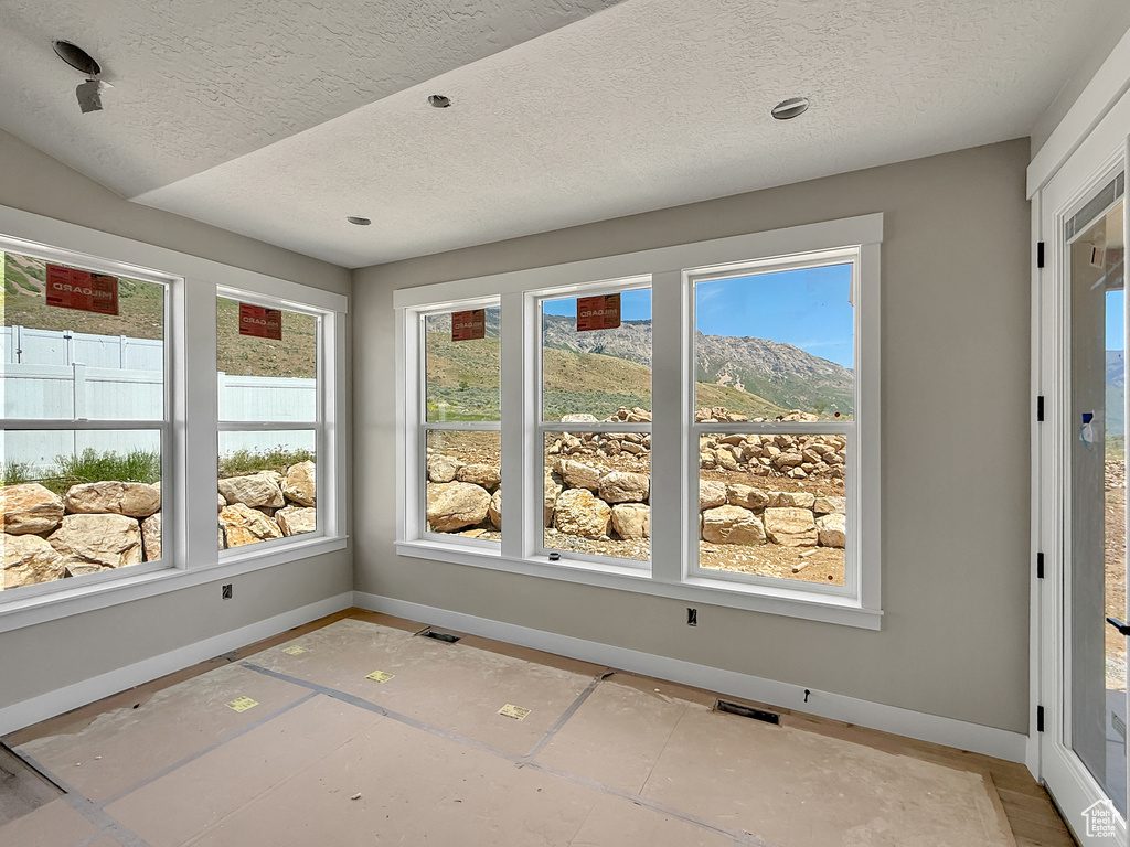 Unfurnished sunroom featuring healthy amount of natural light