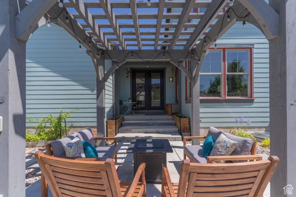 View of patio featuring an outdoor living space, a pergola, and french doors