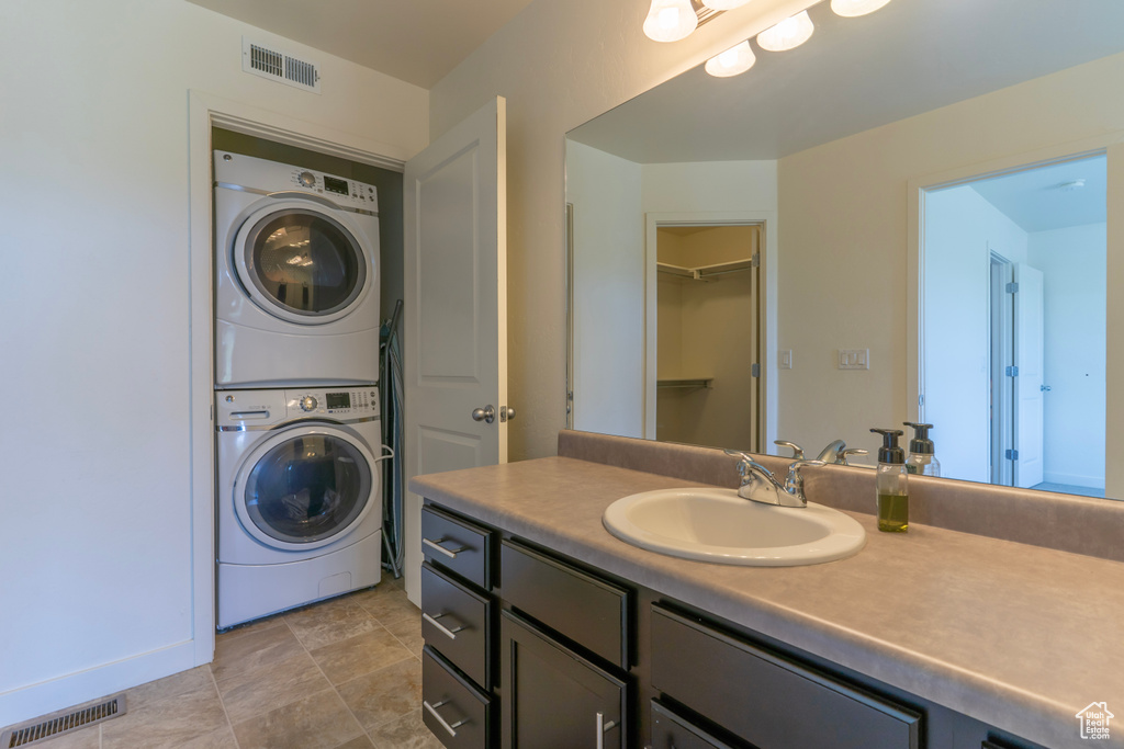 Bathroom with stacked washer / dryer and vanity