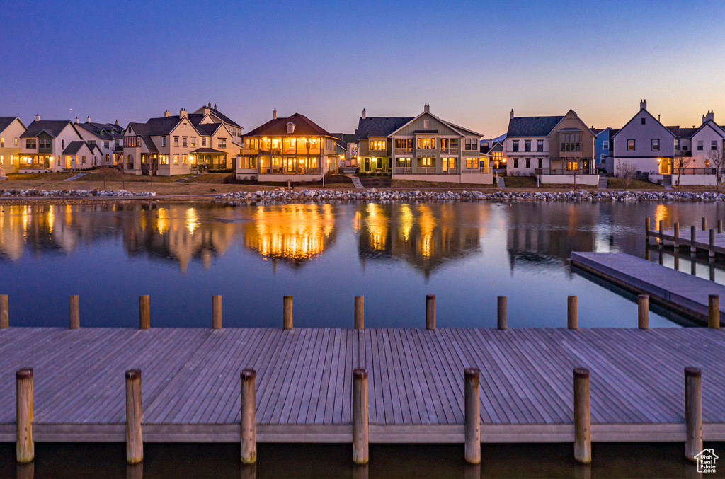 Dock area with a residential view and a water view