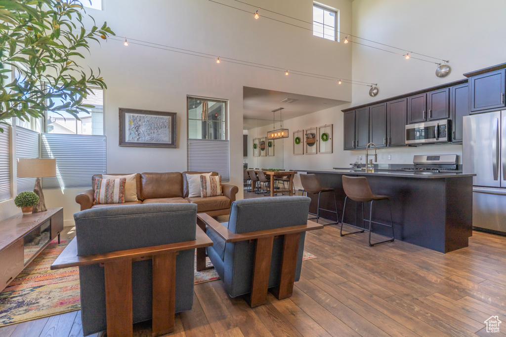 Living area featuring dark wood-type flooring and a high ceiling