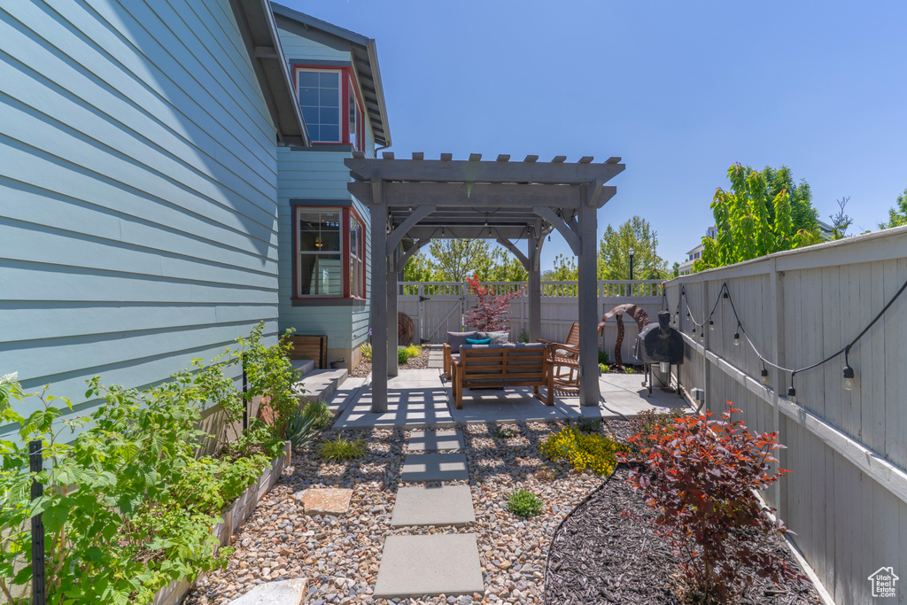 Fenced backyard with a pergola, a patio, and an outdoor hangout area