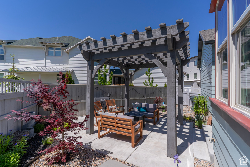 Fenced backyard with outdoor lounge area, a pergola, and a patio