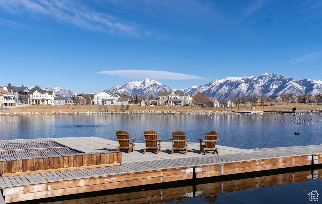 Dock area featuring a water and mountain view and a residential view