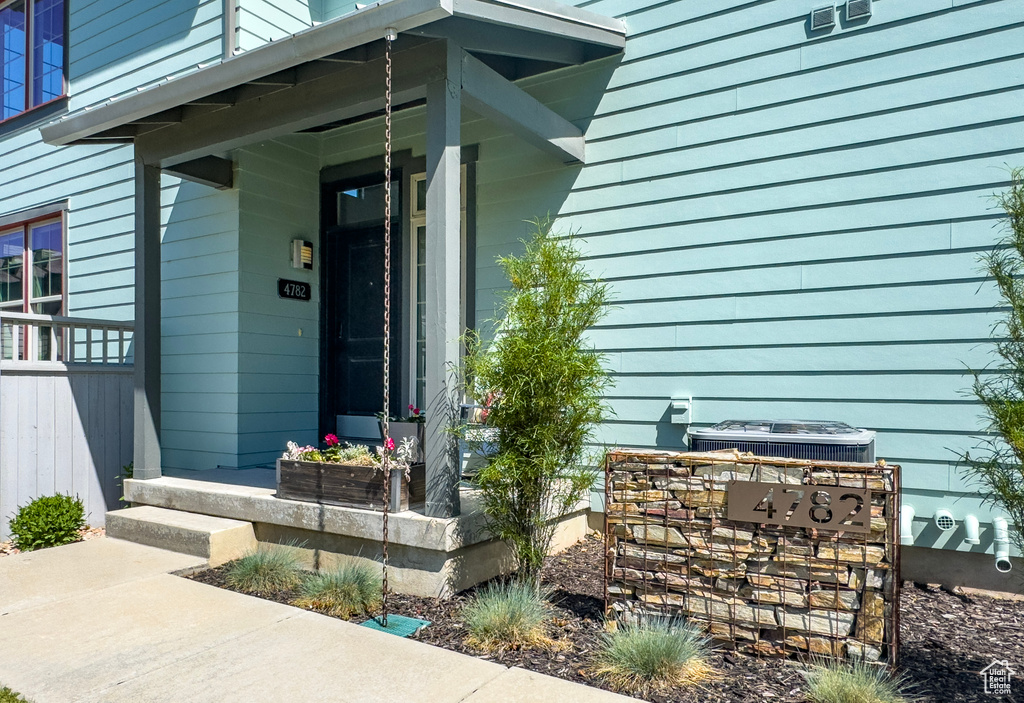 View of exterior entry with a porch