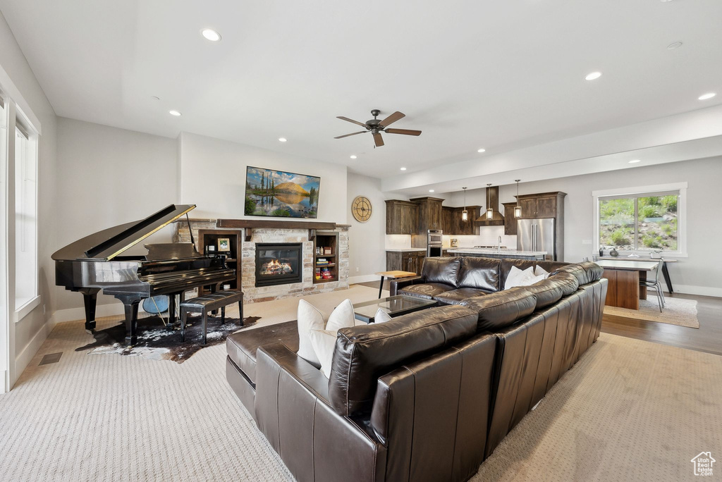 Living area with ceiling fan, recessed lighting, baseboards, and a fireplace