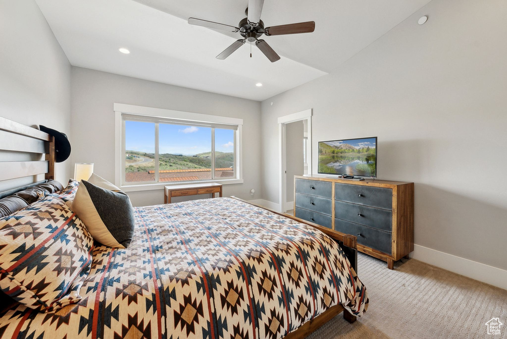 Carpeted bedroom featuring baseboards, ceiling fan, and recessed lighting
