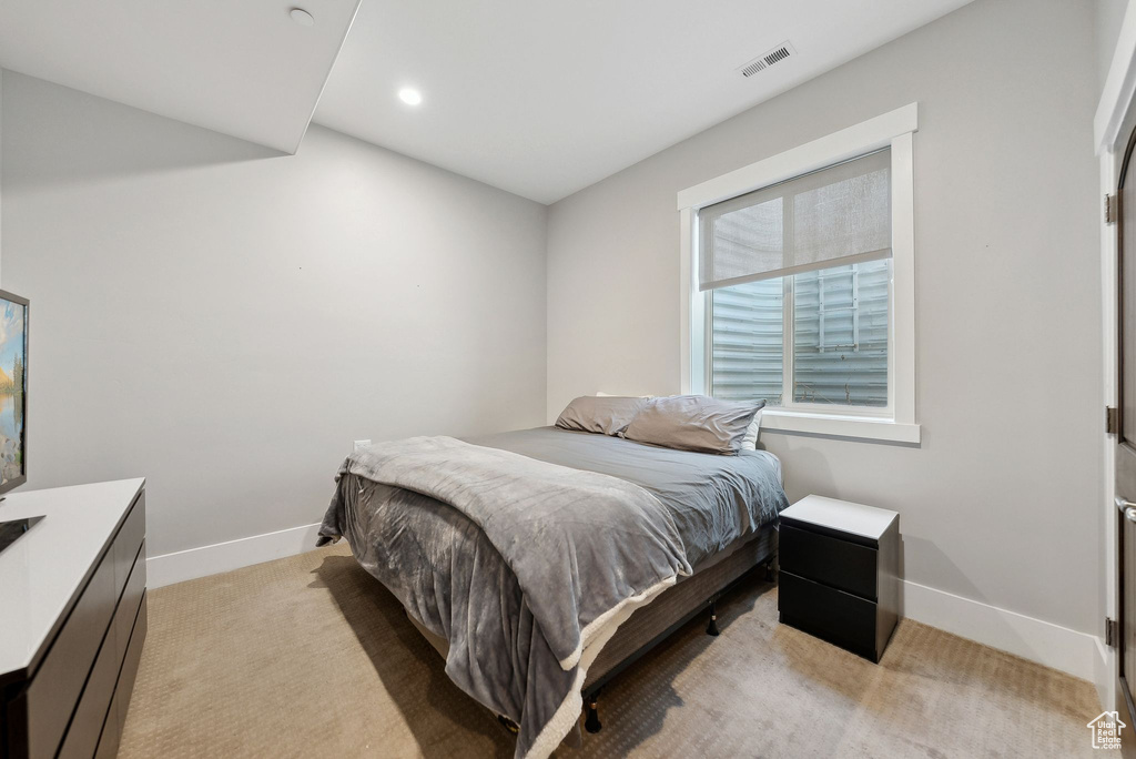 Bedroom with baseboards, light colored carpet, and recessed lighting