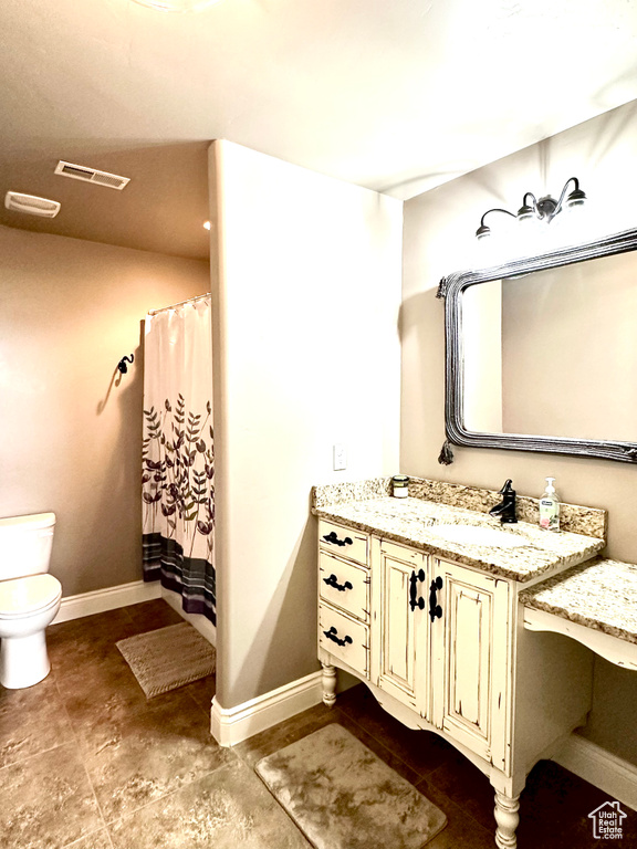 Full bathroom featuring toilet, baseboards, vanity, and a shower with curtain
