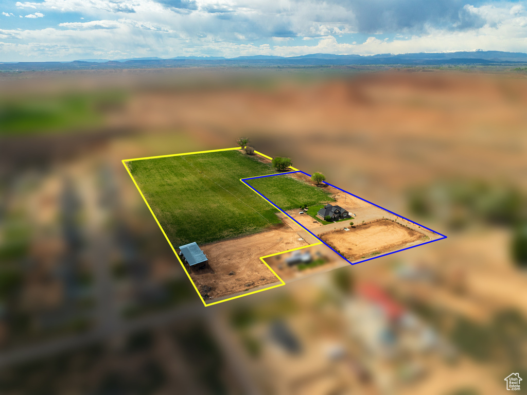 Aerial view of sparsely populated area featuring property parcel outlined and mountains