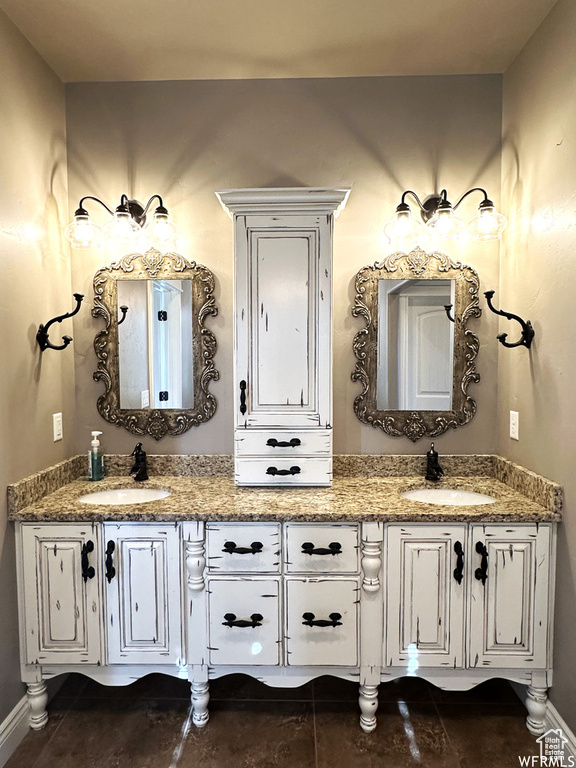 Full bath with double vanity and baseboards