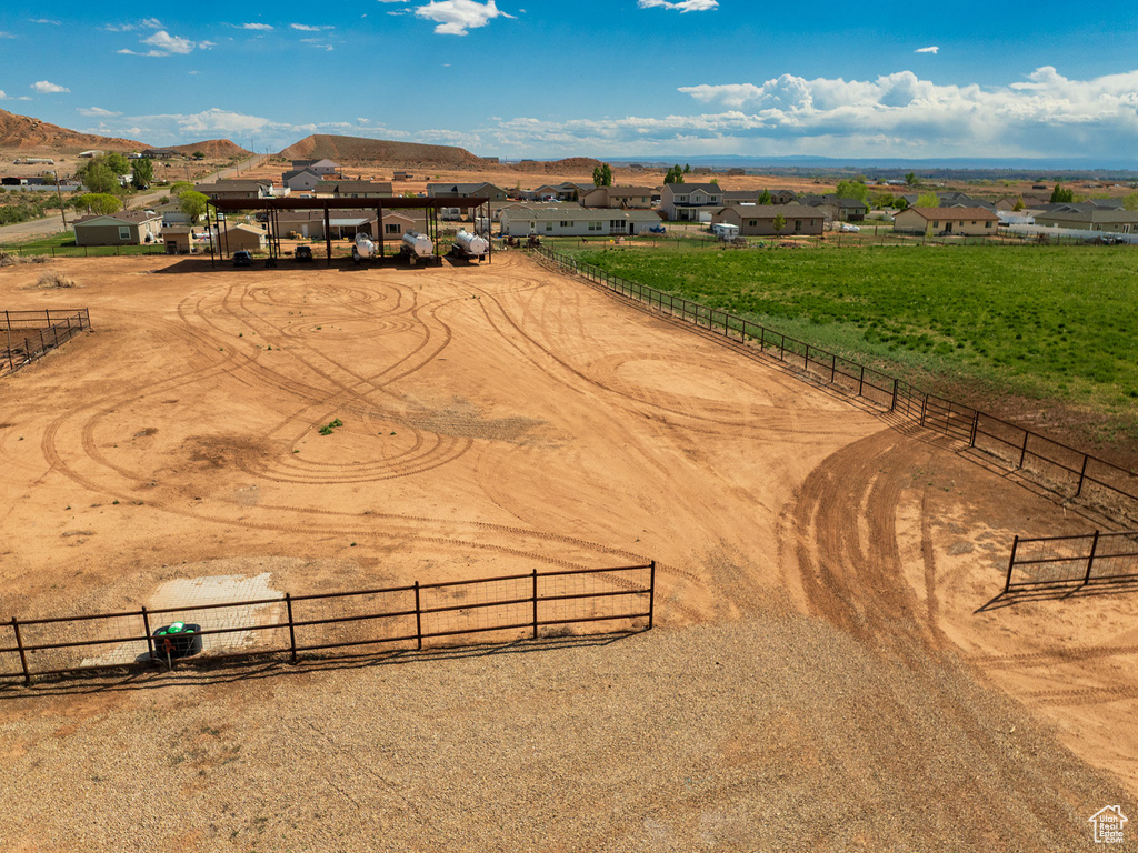 Aerial view of sparsely populated area featuring a mountain backdrop and nearby suburban area