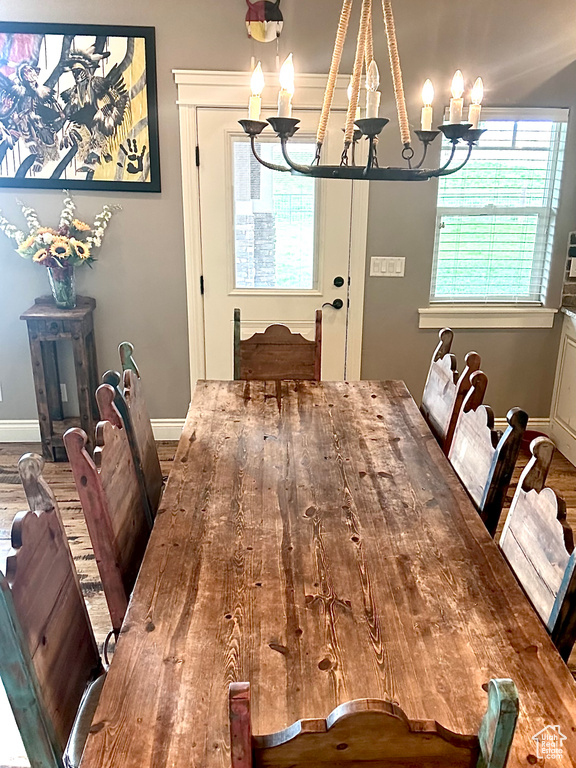 Dining area featuring a chandelier, baseboards, and wood finished floors