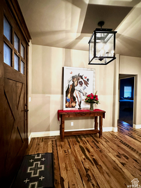 Entrance foyer featuring baseboards and wood finished floors