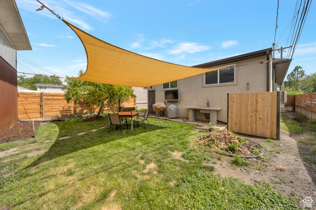 Rear view of property with stucco siding