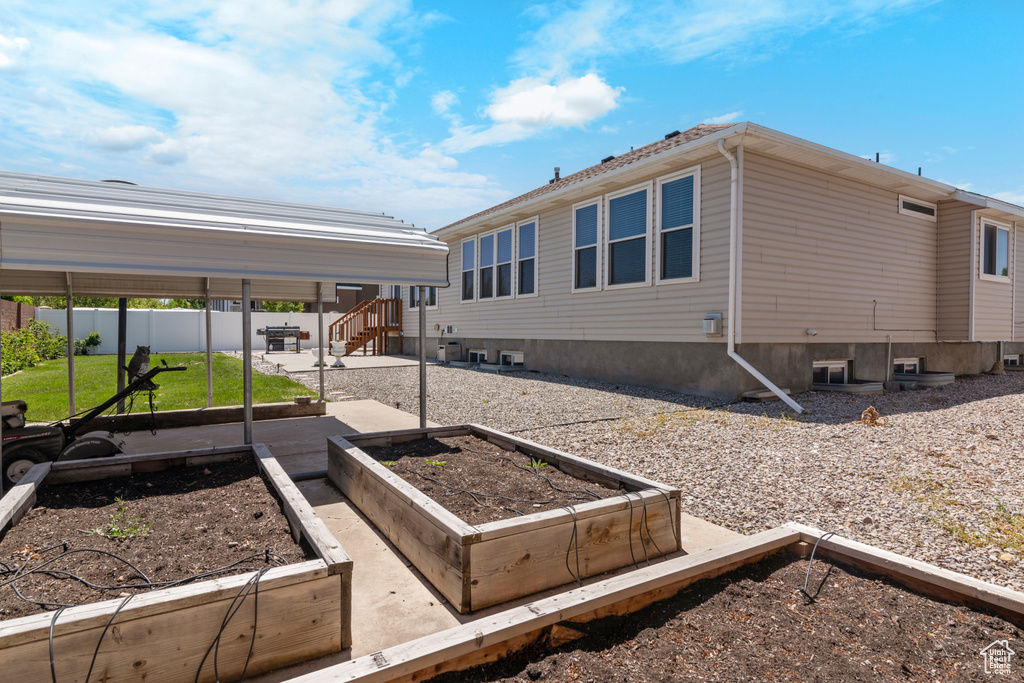 View of property exterior featuring a garden