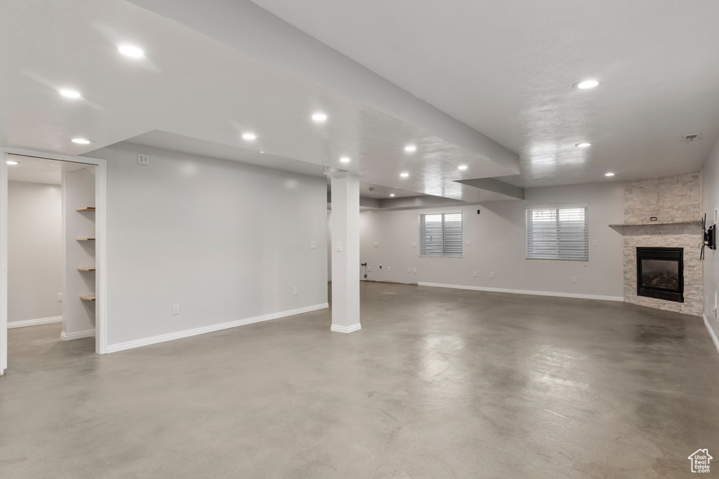 Basement featuring baseboards, recessed lighting, and a fireplace