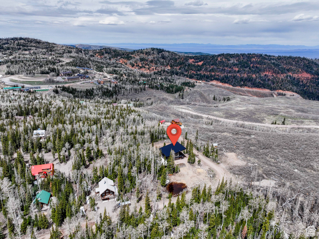Aerial overview of property's location featuring a mountainous background