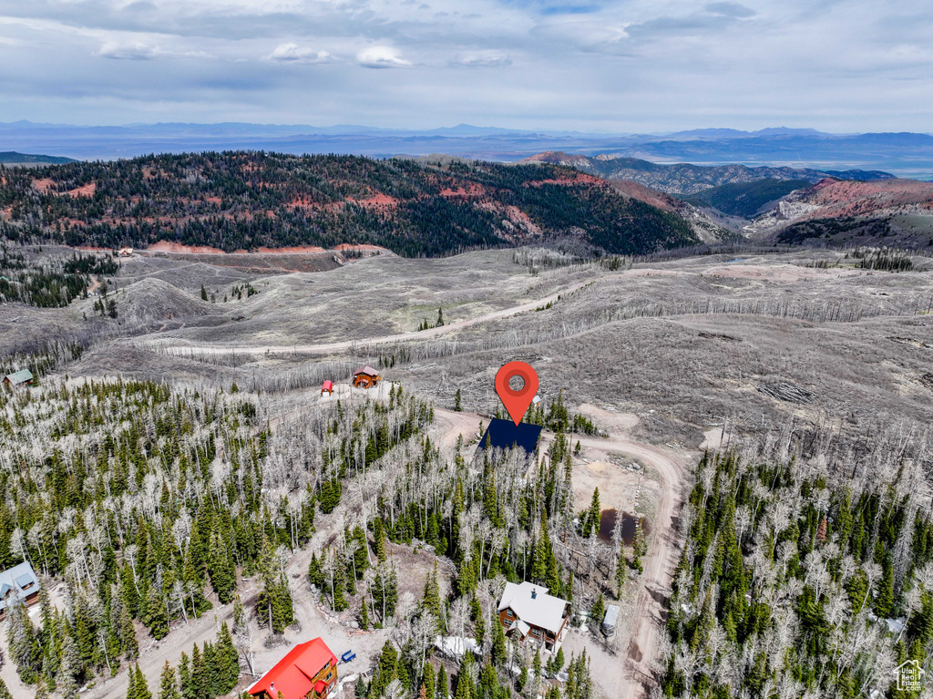 Aerial overview of property's location featuring a mountainous background