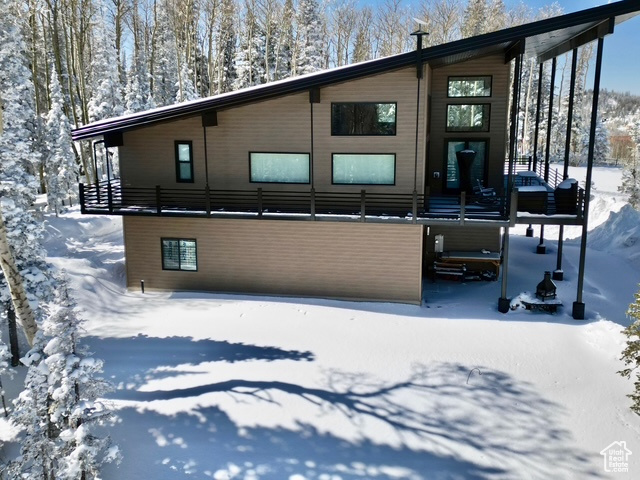 View of snow covered rear of property