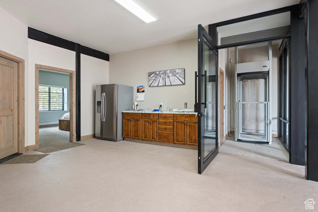 Bathroom featuring carpet floors, baseboard heating, and baseboards