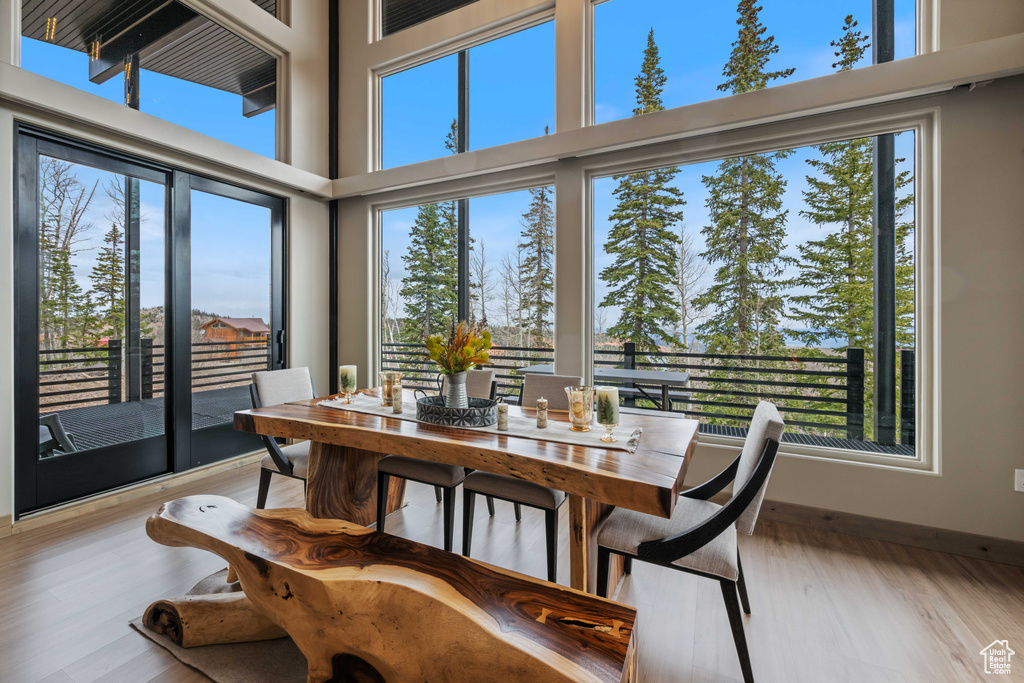 Dining space featuring wood finished floors and a high ceiling