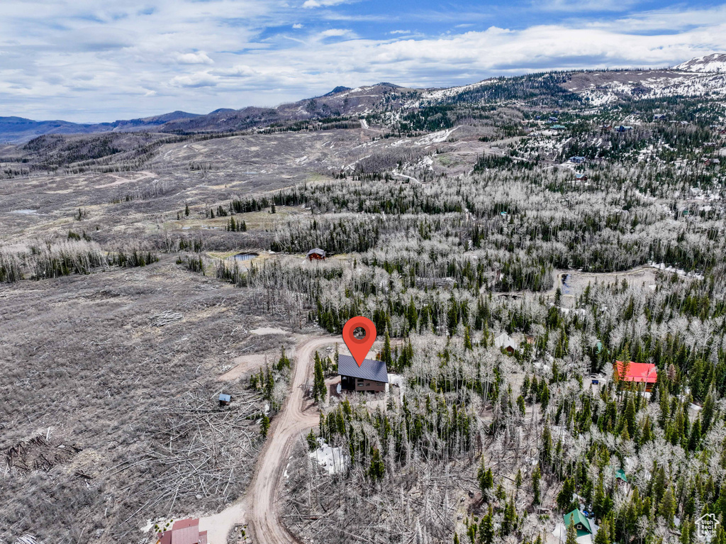 Aerial view of property and surrounding area with a mountainous background