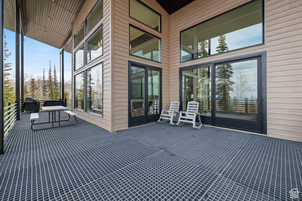 Wooden terrace featuring a grill